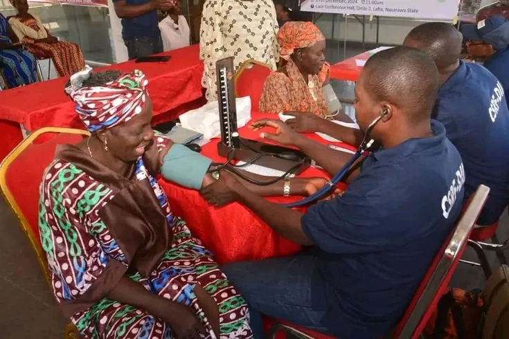 An older woman having her blood pressure checked
